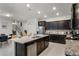 Open kitchen with granite countertops, stainless steel appliances, and adjacent dining area at 4149 Lana Ave, Davenport, FL 33897
