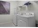 Laundry room with a washer, dryer, iron, and overhead storage shelf at 4149 Lana Ave, Davenport, FL 33897