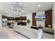 Open-concept living room featuring a modern kitchen, sleek furnishings, and a wall-mounted television at 4149 Lana Ave, Davenport, FL 33897