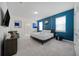 Stylish main bedroom with a blue accent wall, a king-size bed, and contemporary decor, perfect for relaxation at 4149 Lana Ave, Davenport, FL 33897