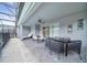 This patio offers seating, loungers, and a ceiling fan with an enclosed pool in the background at 4149 Lana Ave, Davenport, FL 33897