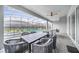 This patio offers comfortable seating and ceiling fan with an enclosed pool and neighboring houses in view at 4149 Lana Ave, Davenport, FL 33897