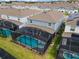 Aerial view of a screened in pool and spa on a well-maintained property at 4149 Lana Ave, Davenport, FL 33897