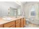Bright bathroom with double vanity, tile floors, shower, and natural light at 4263 Lillian Hall Ln, Orlando, FL 32812