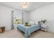Bright bedroom features a ceiling fan, carpet floors, and a window with floral curtains at 4263 Lillian Hall Ln, Orlando, FL 32812
