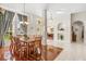 Bright dining room featuring wood floors, a chandelier, and large windows at 4263 Lillian Hall Ln, Orlando, FL 32812