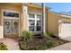 Inviting home exterior with a decorative front door, manicured landscaping, and a brick walkway at 4263 Lillian Hall Ln, Orlando, FL 32812