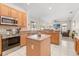 Open-concept kitchen features stainless appliances, granite counters, and seamless flow to the living area at 4263 Lillian Hall Ln, Orlando, FL 32812