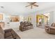 Open-concept living room with sliding glass doors, comfortable seating, and adjacent kitchen at 4263 Lillian Hall Ln, Orlando, FL 32812