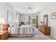 Spacious main bedroom with neutral paint, ceiling fan, dresser, and glass doors to the lanai at 4263 Lillian Hall Ln, Orlando, FL 32812