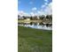A picturesque pond sits amidst lush greenery and a bright blue sky at 4263 Lillian Hall Ln, Orlando, FL 32812