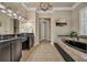 Elegant bathroom with a soaking tub, modern fixtures, and tile floors at 4533 Burke St, Orlando, FL 32814