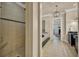 Elegant bathroom with a walk-in shower, soaking tub, modern fixtures, and tile floors at 4533 Burke St, Orlando, FL 32814