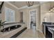 Elegant bathroom with a soaking tub, modern fixtures, and tile floors at 4533 Burke St, Orlando, FL 32814