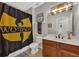 Bathroom with a dark wood vanity, a black shower curtain, and modern lighting at 4533 Burke St, Orlando, FL 32814