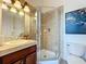 A well-lit bathroom features a tiled shower with glass door, complementing the neutral and stylish design at 4533 Burke St, Orlando, FL 32814