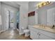 Standard bathroom with neutral tile flooring, a single vanity, and an open view to a walk-in closet at 4533 Burke St, Orlando, FL 32814