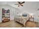 Bright bedroom with hardwood floors, ceiling fan, and a cozy reading nook by the window at 4533 Burke St, Orlando, FL 32814