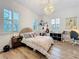 Bedroom with white walls, wood floor, shutters and unique light fixture at 4533 Burke St, Orlando, FL 32814