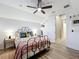 Bedroom with a ceiling fan, shutters on the windows, hardwood floors, and stylish decor at 4533 Burke St, Orlando, FL 32814