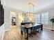 Dining room featuring a modern chandelier, long table, and luxury finishes at 4533 Burke St, Orlando, FL 32814