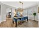Dining room with a chandelier, hardwood floors, and large windows with plenty of natural light at 4533 Burke St, Orlando, FL 32814