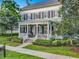 Charming two-story home with inviting front porch, landscaped yard, and classic architectural details at 4533 Burke St, Orlando, FL 32814