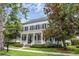 Charming two-story home with a inviting front porch, classic shutters, and well-maintained landscaping at 4533 Burke St, Orlando, FL 32814