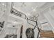 Spacious foyer featuring a decorative display cabinet, staircase, and an open view of the living area at 4533 Burke St, Orlando, FL 32814