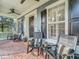 Expansive front porch with relaxing seating, ceiling fan, and classic architectural charm at 4533 Burke St, Orlando, FL 32814