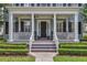 Inviting front porch with black rocking chairs, fresh plants, and a welcoming entrance at 4533 Burke St, Orlando, FL 32814