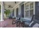 Relaxing front porch with rocking chairs, brick flooring, and views of lush greenery at 4533 Burke St, Orlando, FL 32814