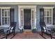 Inviting front porch featuring rocking chairs, a welcome mat, and decorative potted plants at 4533 Burke St, Orlando, FL 32814