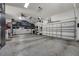 Spacious garage with a car lift, high ceilings, an epoxy floor, and multiple garage doors at 4533 Burke St, Orlando, FL 32814