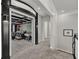 Hallway with dark trim leading to a home theater room with seating and a foosball table at 4533 Burke St, Orlando, FL 32814
