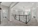 Upstairs hallway featuring plush carpeting, modern lighting, and access to bedrooms and living spaces at 4533 Burke St, Orlando, FL 32814