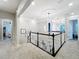 Upstairs hallway with carpet, white trim and doors and modern lighting fixtures at 4533 Burke St, Orlando, FL 32814
