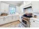 Kitchen showcasing marble countertops, stainless steel appliances, and white cabinets at 4533 Burke St, Orlando, FL 32814