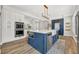 Modern kitchen with a large center island, stainless steel appliances, and custom cabinets at 4533 Burke St, Orlando, FL 32814