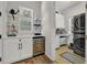 Bright laundry room featuring a wine cooler, cabinets, and modern washer and dryer at 4533 Burke St, Orlando, FL 32814