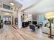 Open-concept living room with high ceilings, light hardwood floors and staircase at 4533 Burke St, Orlando, FL 32814