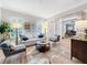 Bright living room with wood floors, stylish furniture, and large windows with plantation shutters at 4533 Burke St, Orlando, FL 32814