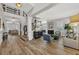 Bright living room with hardwood floors, elegant furnishings, and staircase access at 4533 Burke St, Orlando, FL 32814
