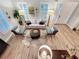 Bright living room with wood floors, white sofa, and bright natural light at 4533 Burke St, Orlando, FL 32814