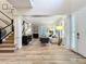 Bright living room with hardwood floors, staircase, pillars, and many windows at 4533 Burke St, Orlando, FL 32814