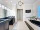 The main bath includes double sinks, a large tub, and bright lighting at 4533 Burke St, Orlando, FL 32814