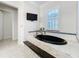 The main bathroom features a luxurious black soaking tub with a tile surround and shutters at 4533 Burke St, Orlando, FL 32814