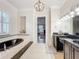 The main bathroom boasts double sinks, a soaking tub, and natural light at 4533 Burke St, Orlando, FL 32814