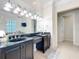Bright and airy bathroom featuring double sinks with granite counters and modern fixtures at 4533 Burke St, Orlando, FL 32814