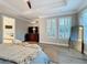 This main bedroom offers wood floors, plantation shutters, and backyard views at 4533 Burke St, Orlando, FL 32814